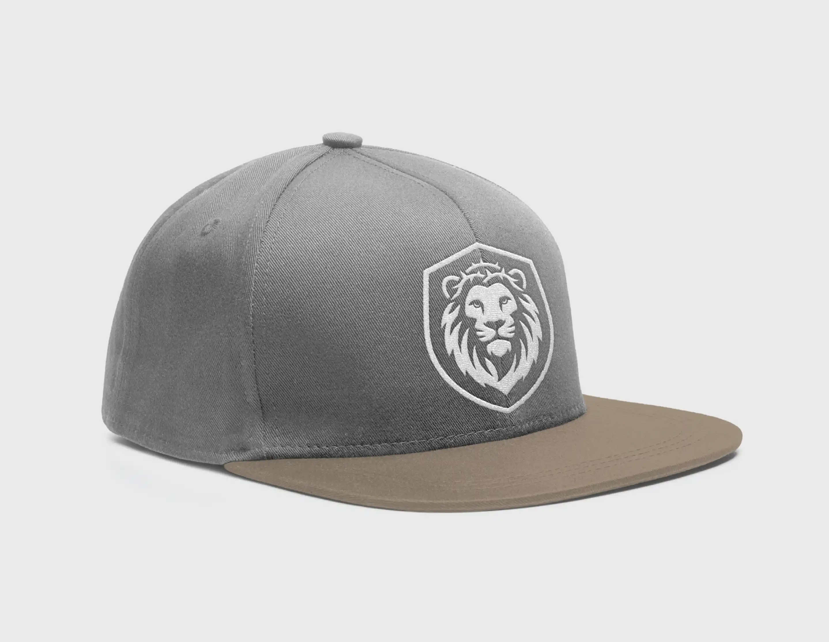 Gray baseball cap with a brown flat brim and an embroidered lion logo in a shield on the front.