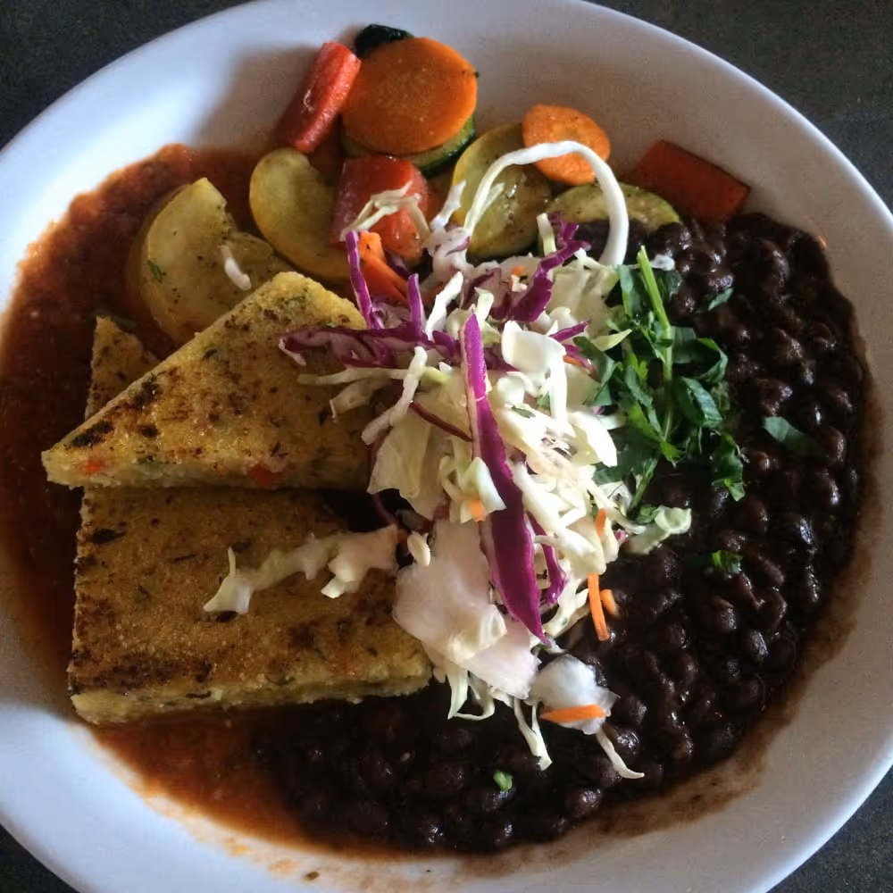 A plate of food with a variety of vegetables and meat.