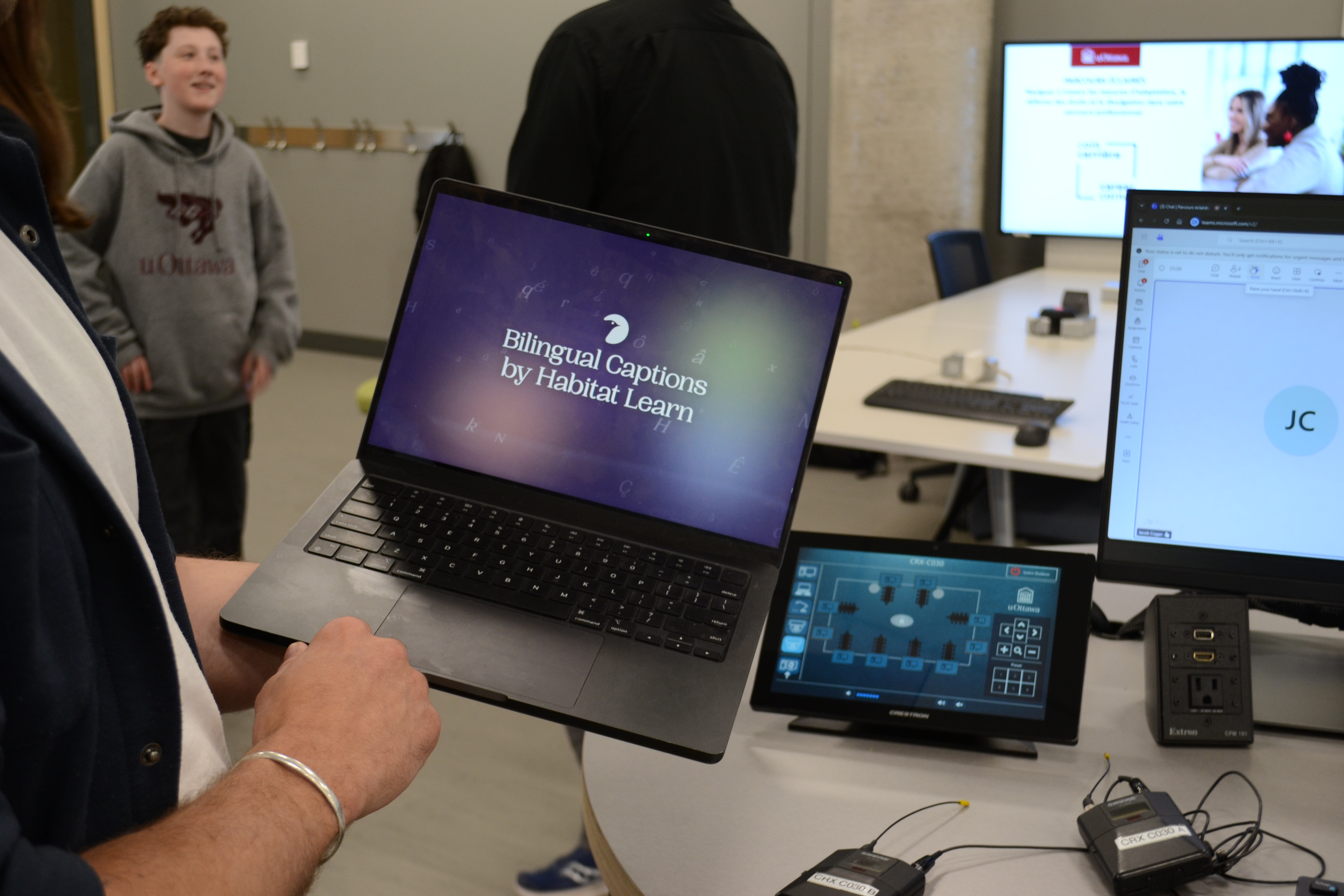 Laptop showing the text Bilingual Captions by Habitat Learn