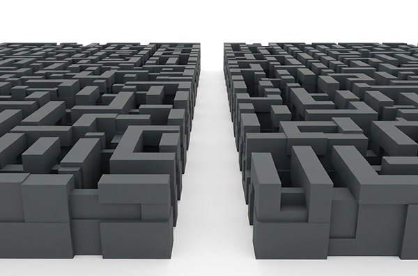 An overhead view of a dense, dark gray 3D maze on both sides, with a clean white path running straight through the center, symbolizing clarity and direction emerging from confusion.