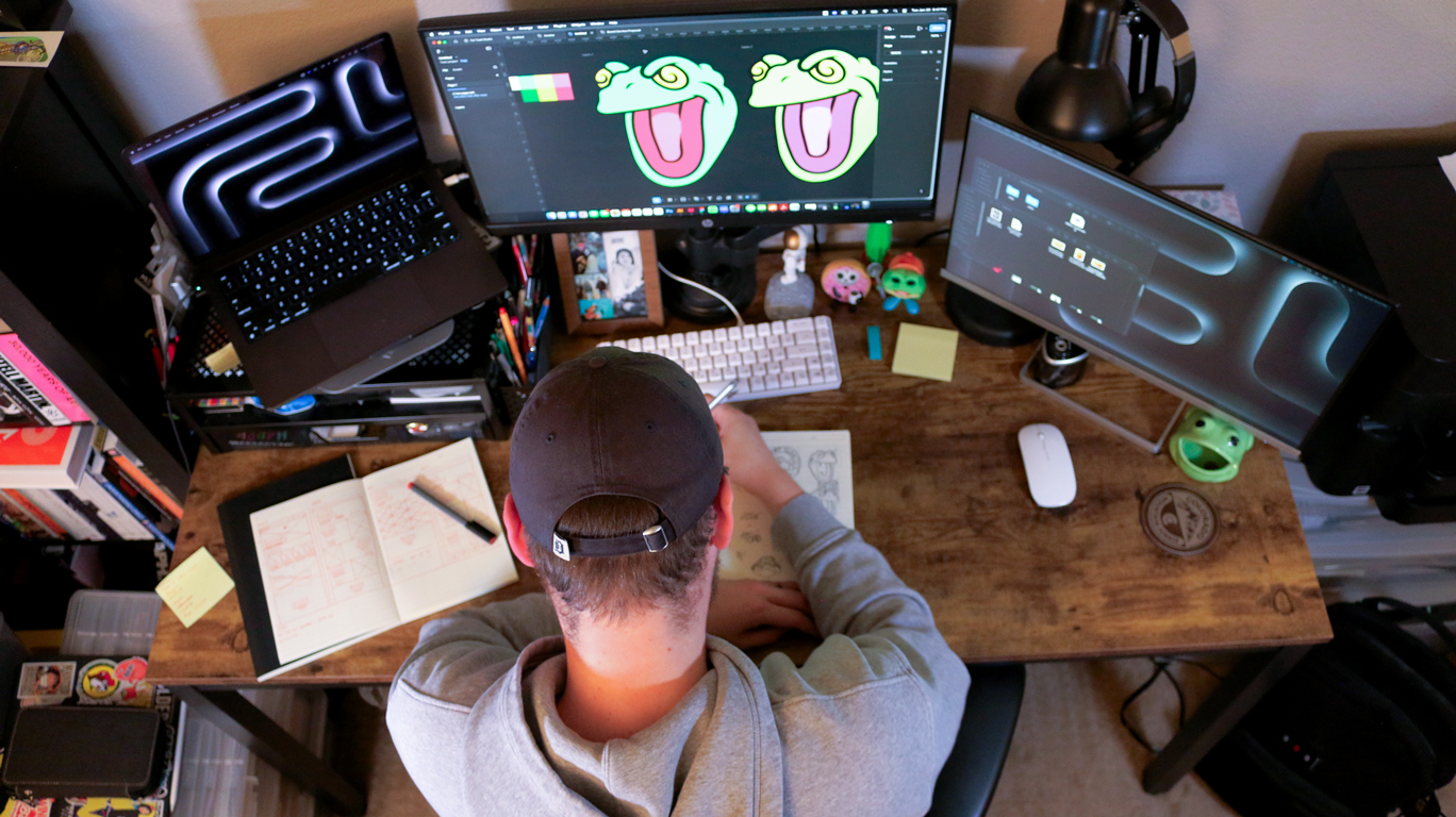 Overhead view of the studio workspace with sketches, tools, and laptop for branding work.
