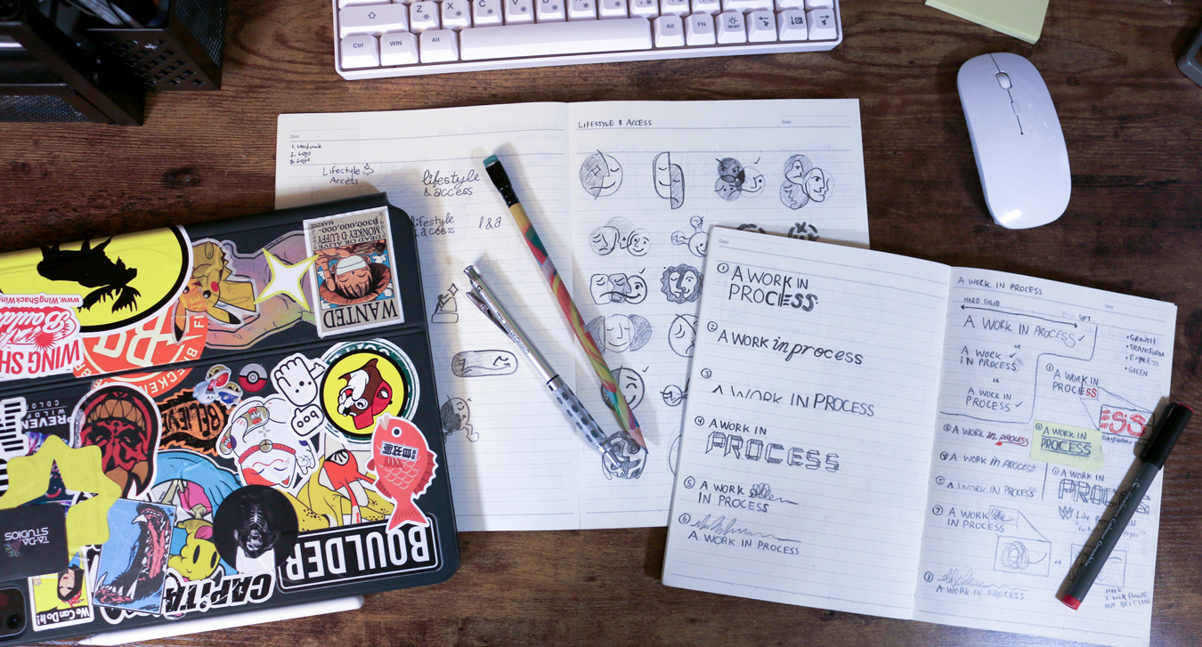 Sketchbook pages filled with hand-drawn logo concepts and explorations.