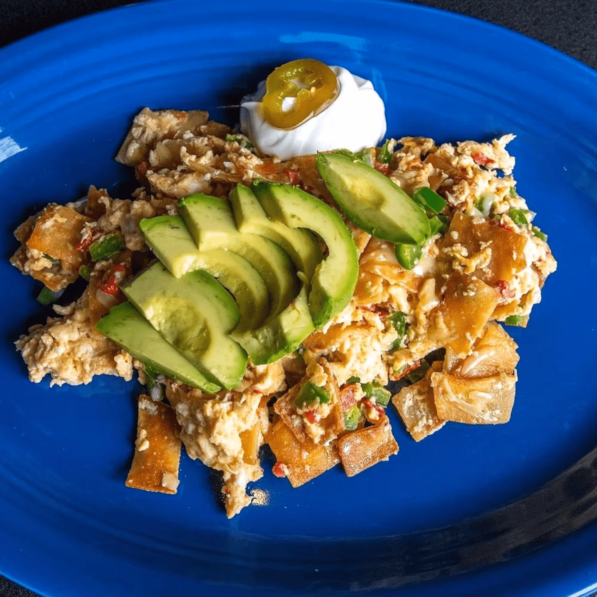 A plate of food with a blue plate and a blue background.