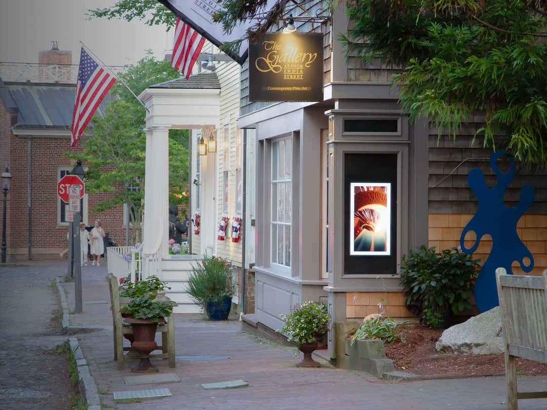 High-end digital signage installed in the window of The Gallery at Four India Street, a Nantucket fine art gallery, designed and managed on-island by Nantucket Studio.