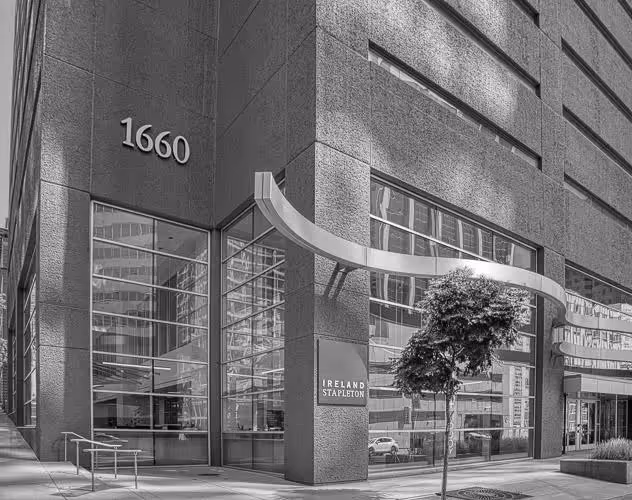 Modern office building corner with large windows, address number 1660, and Ireland Stapleton sign.
