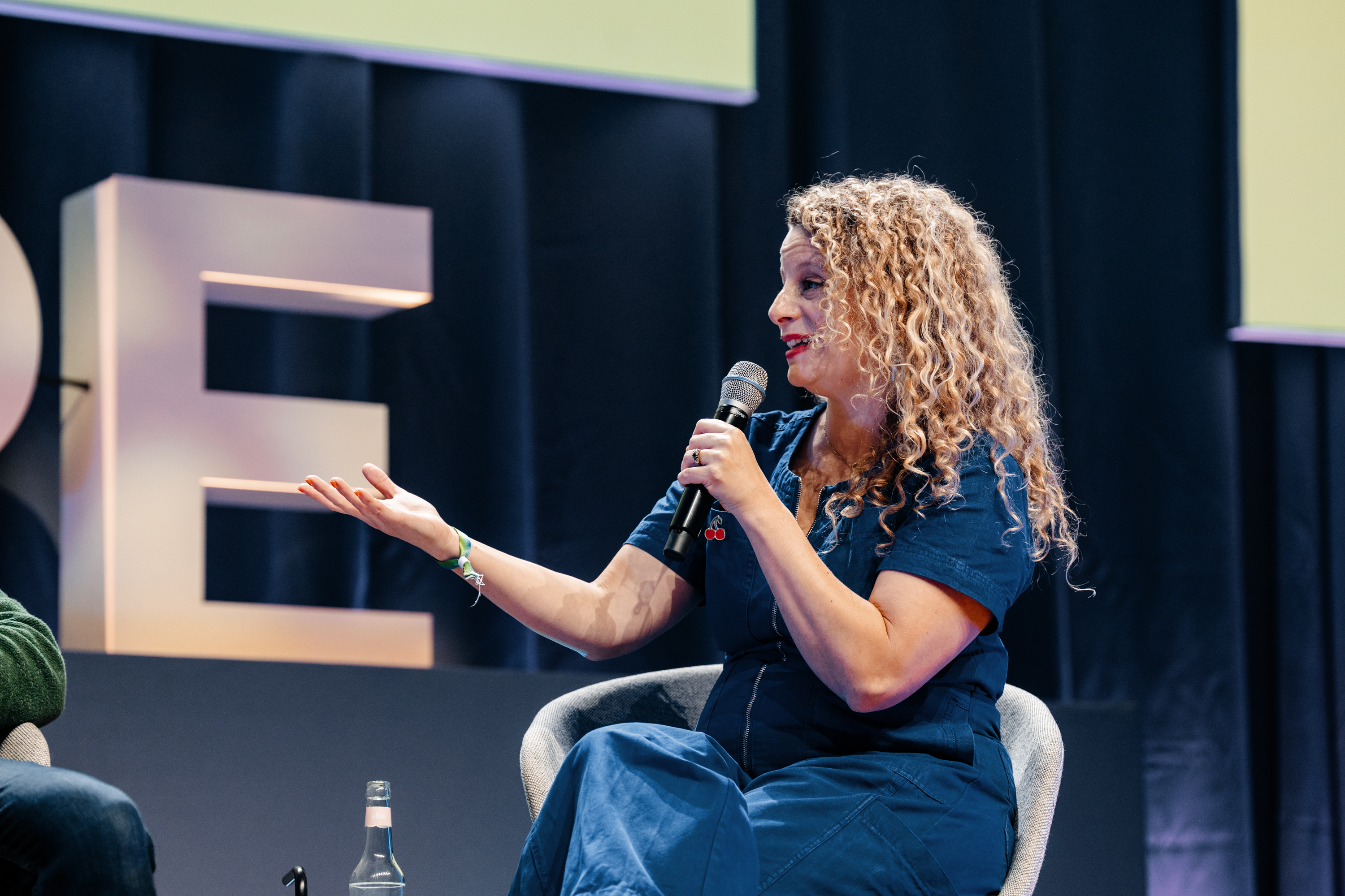 Rebecca Rowntree interviewing a guest on stage