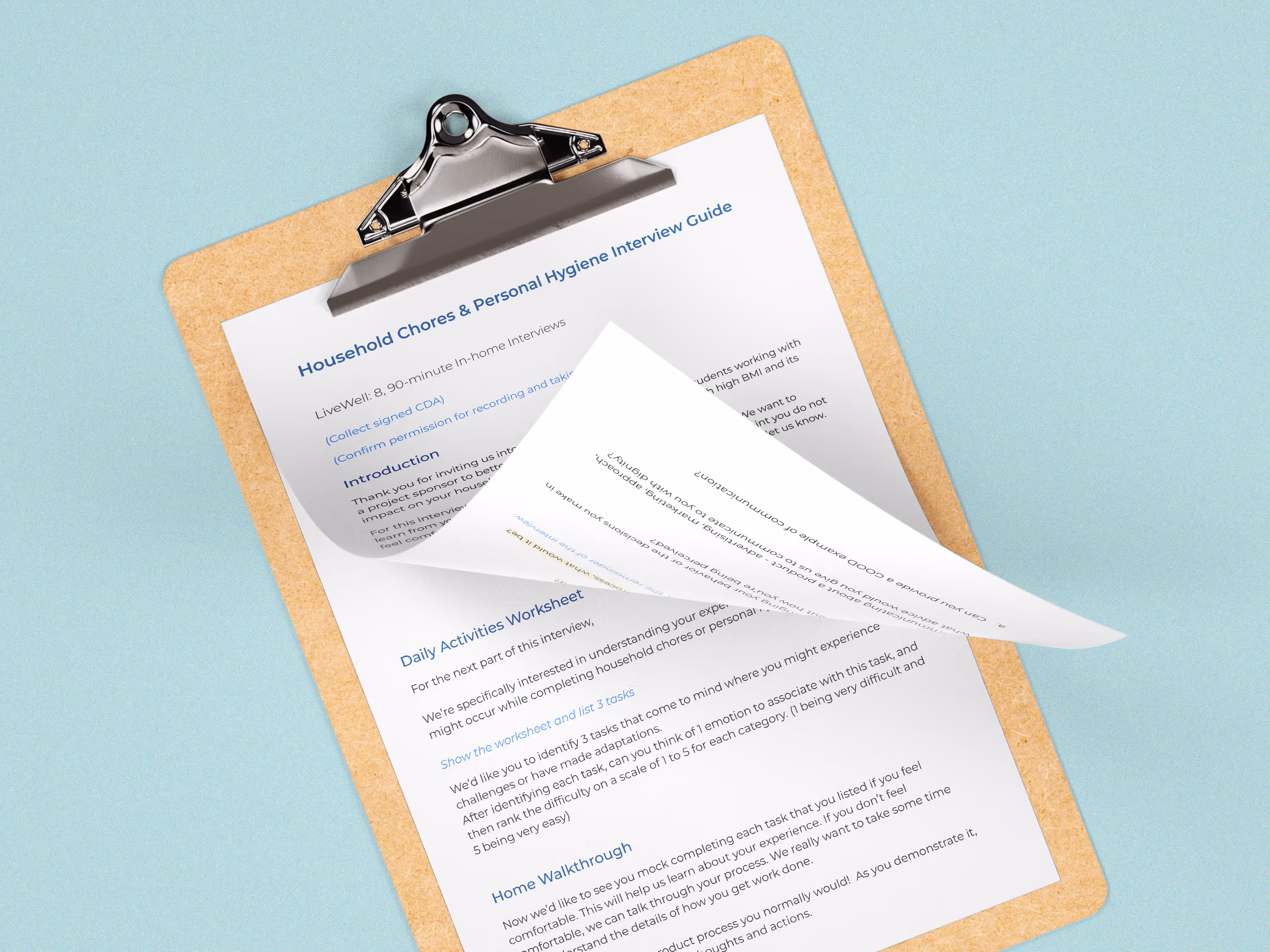 A clipboard with pages from an interview guide that researchers used to gather data. The top page is flipped up revealing the backside of the top page as well as the page underneath.