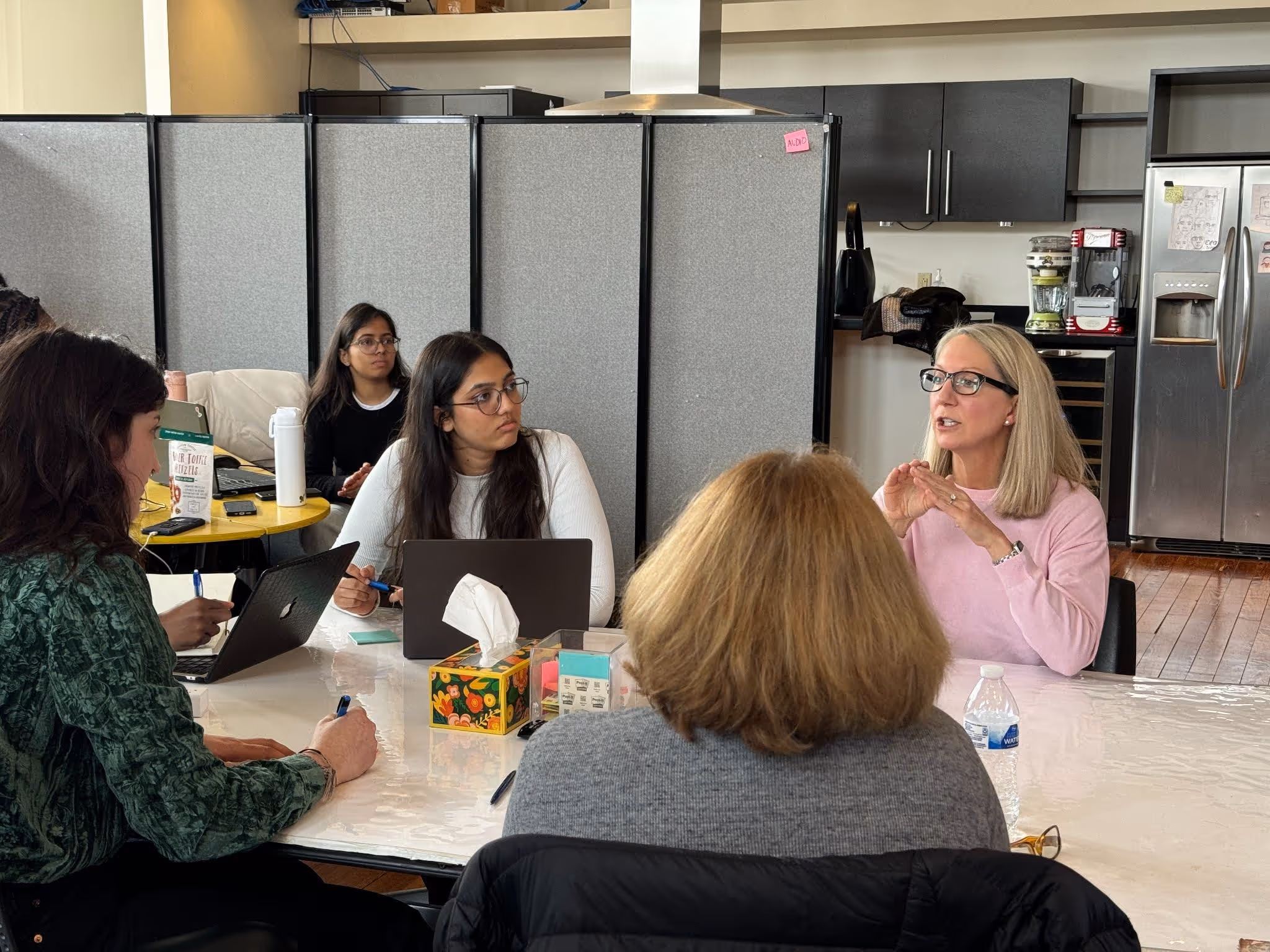Three female students listen attentively as a female flight attendant describes her experience supporting passengers with disabilities.