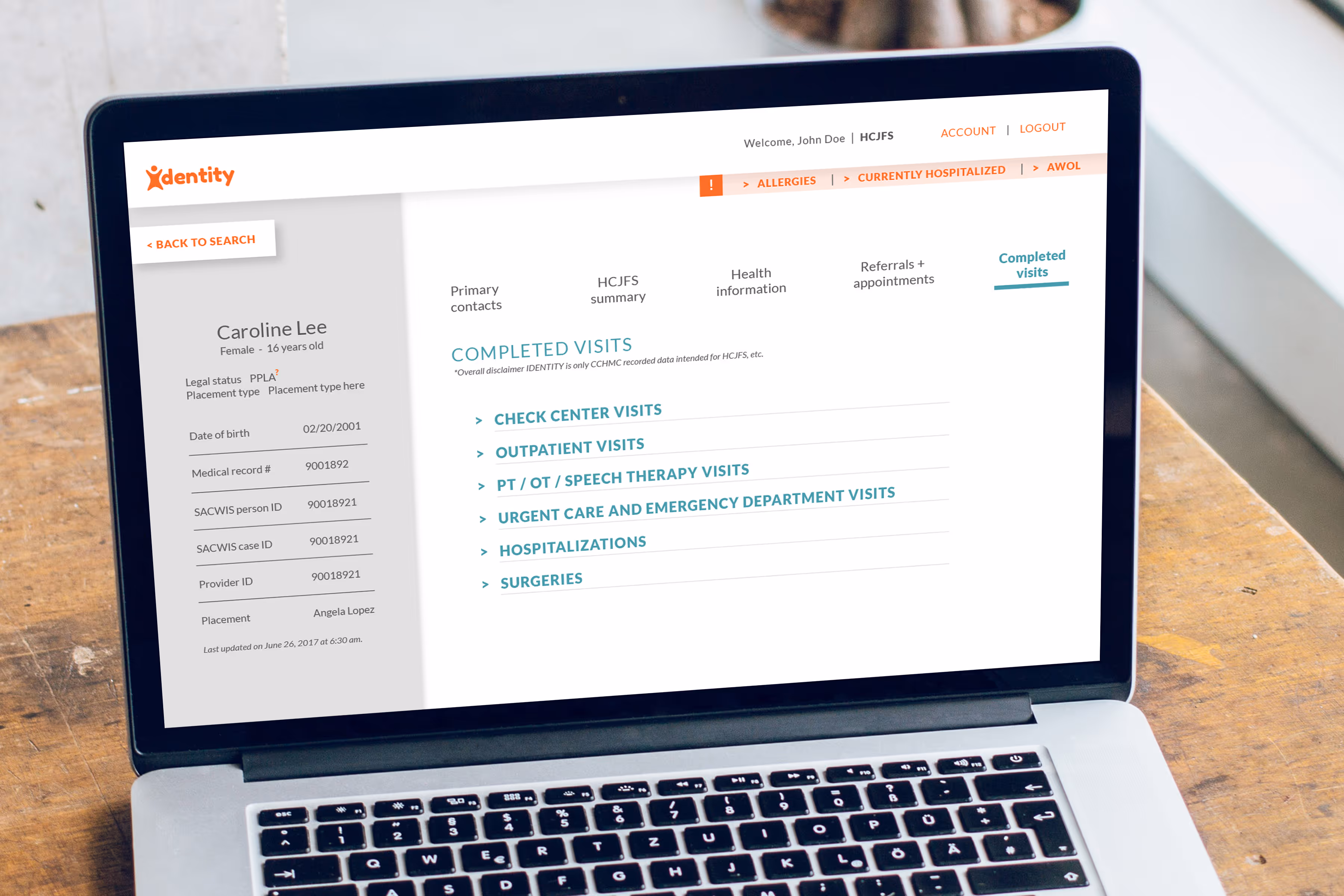 Close up shot of a Macbook pro laptop screen showcasing the design of the IDENTITY healthcare portal for foster youth.