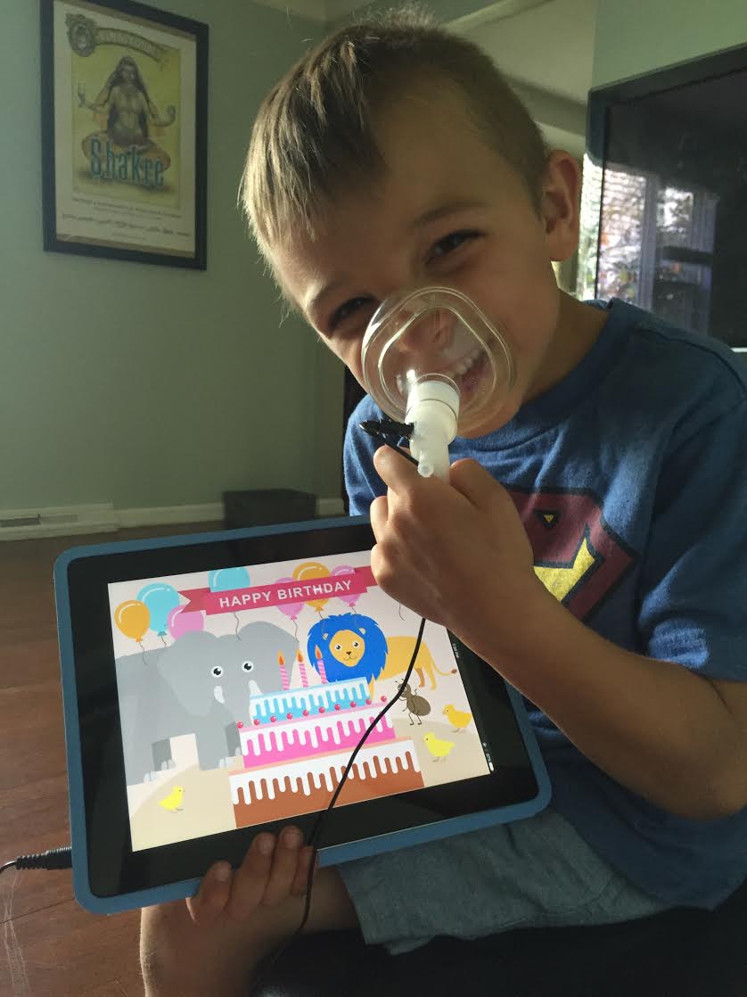 A child testing the induction app and mask