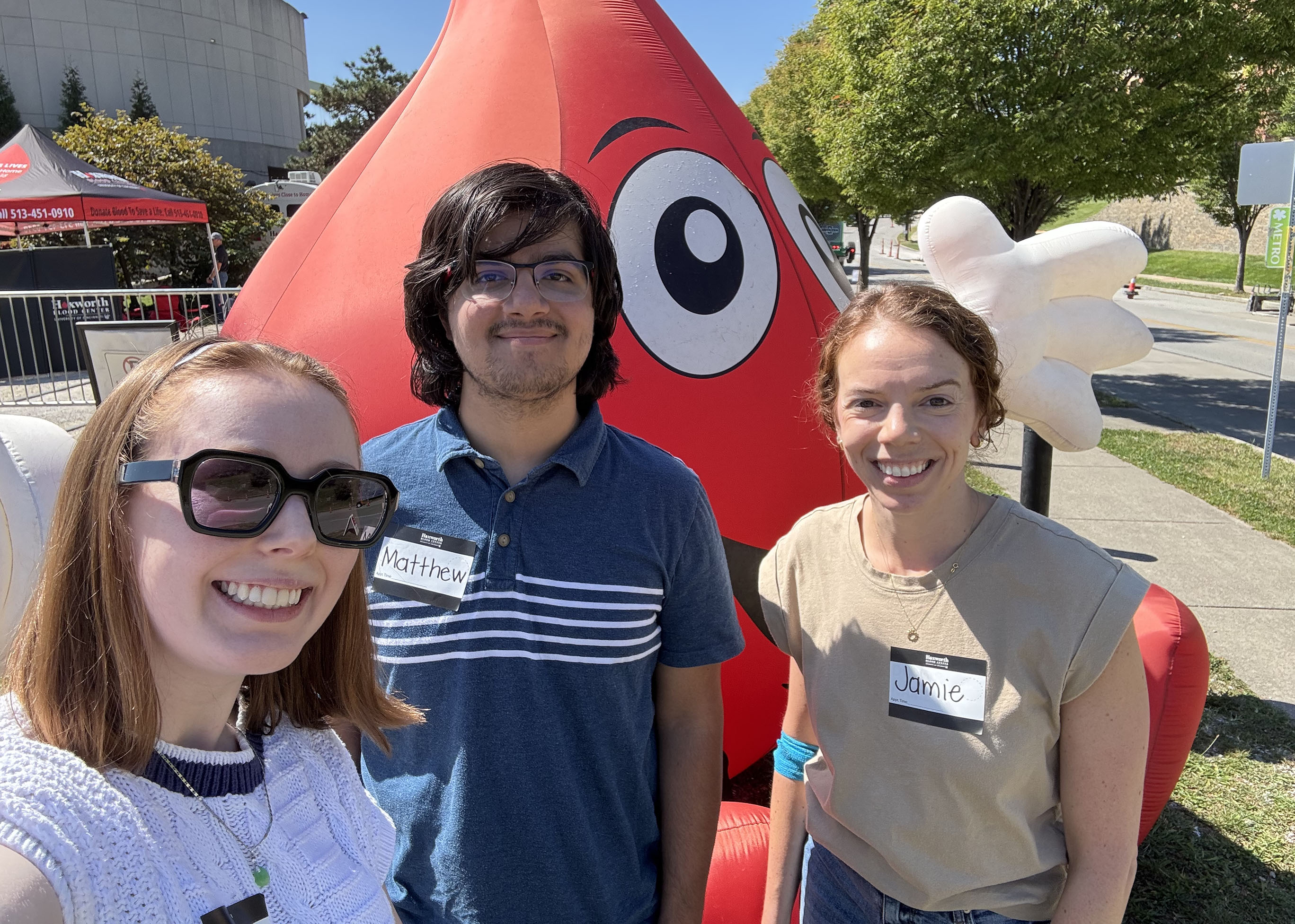 A picture of three team members after giving blood at a mobile drive
