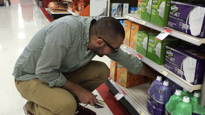 A person bent over looking at a store shelf