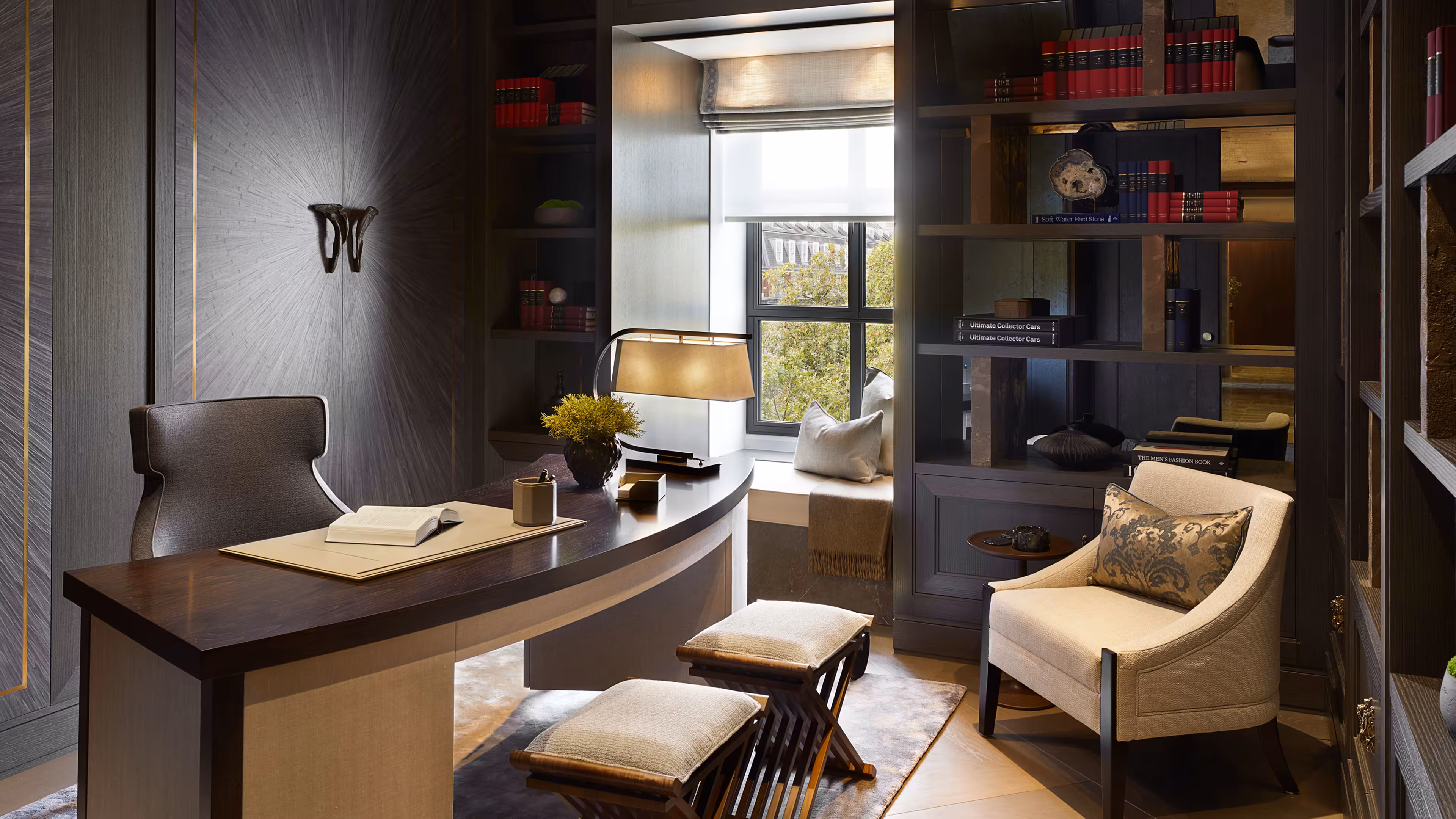A study area featuring dark wooden furniture, table and bookcase.