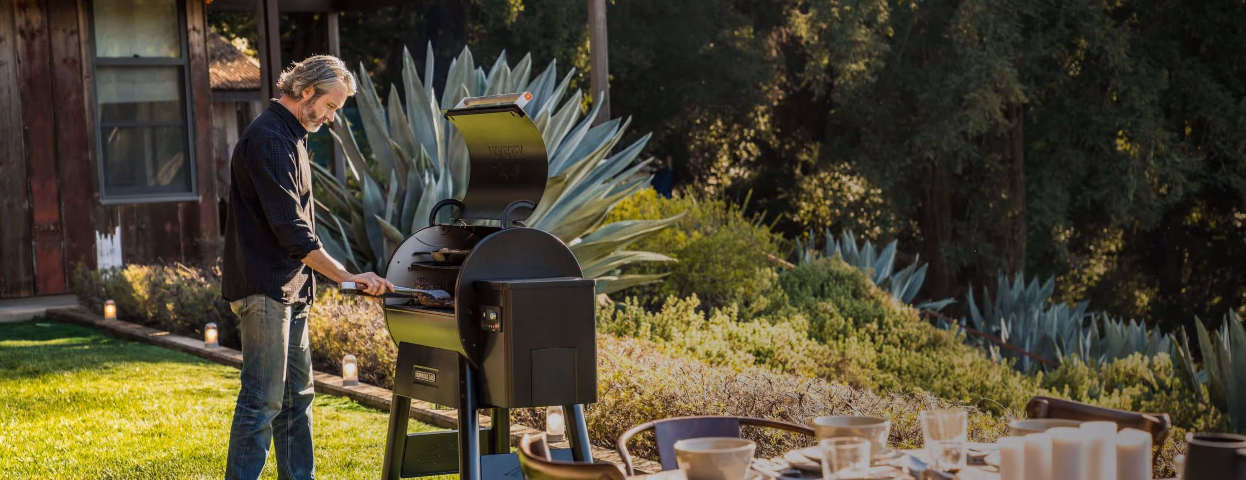 En person bruker en Traeger trepelletsgrill.