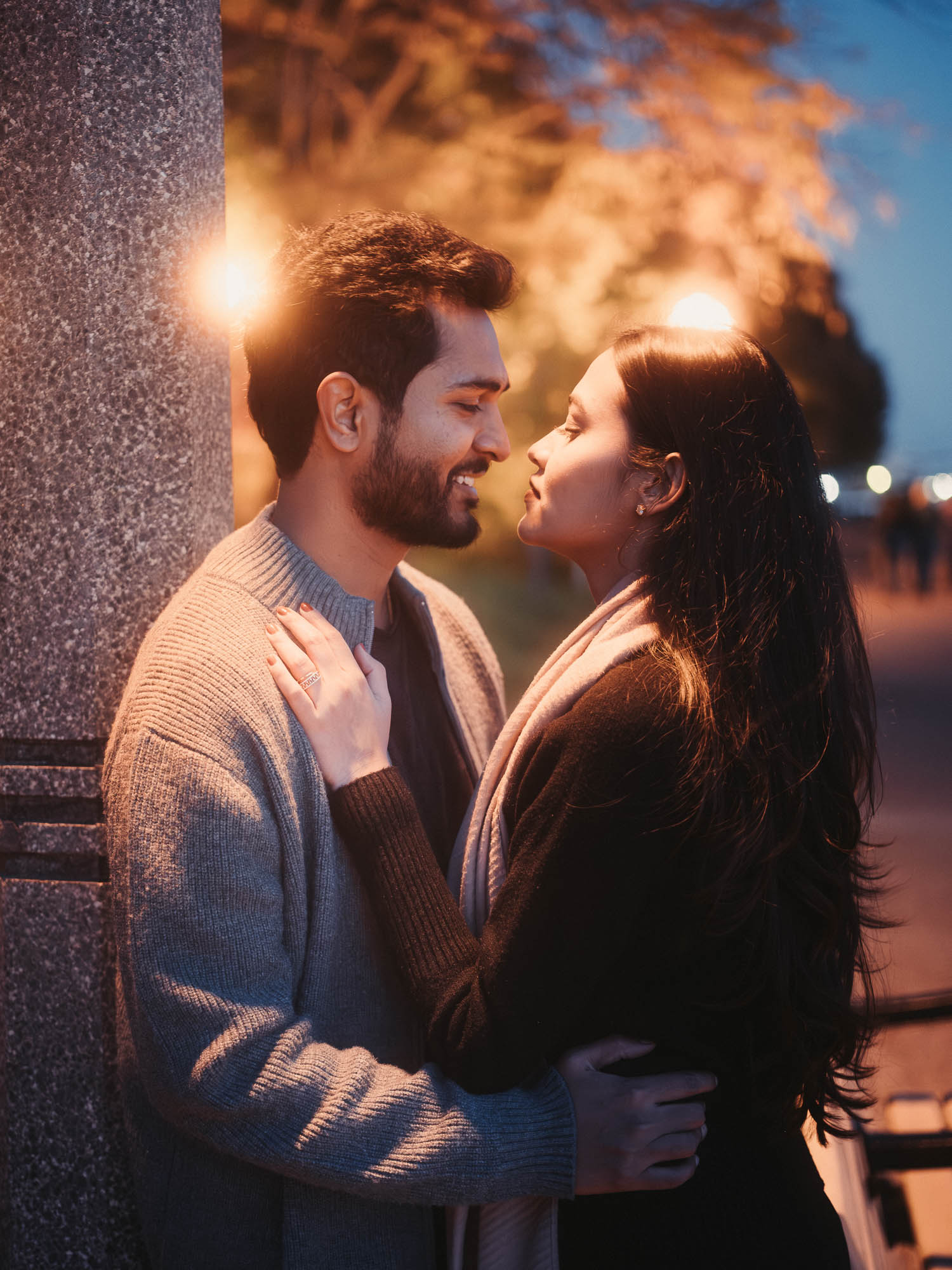 A very intimate couples fall cozy photoshoot at night under a glowy lamp pole at Toronto Musical Gardens with Kash Klicks Studios  