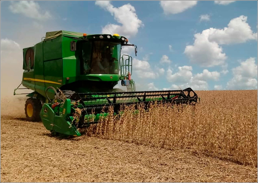 Agricultural tractor operating in a soybean field