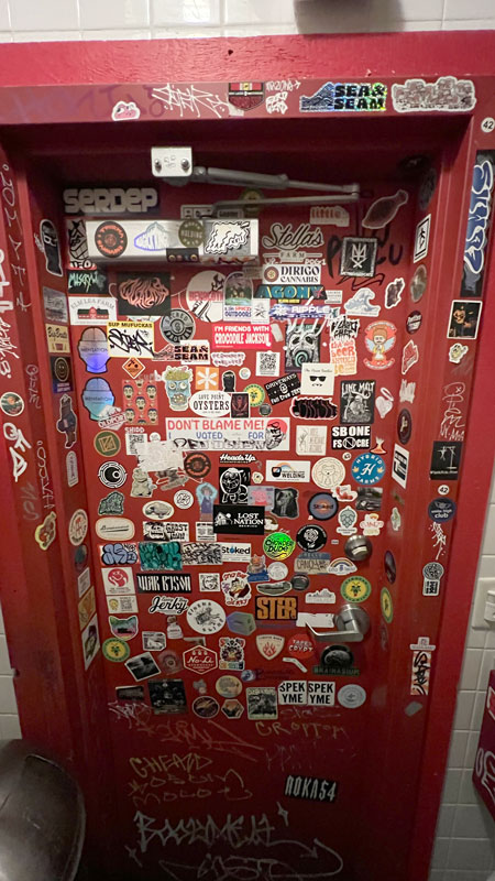Stickers covering bathroom wall