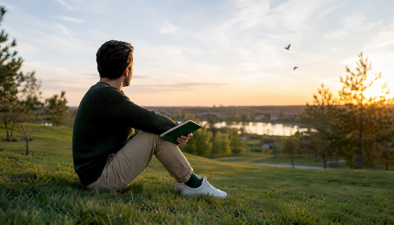 Man reflecting in park linking mental and physical health