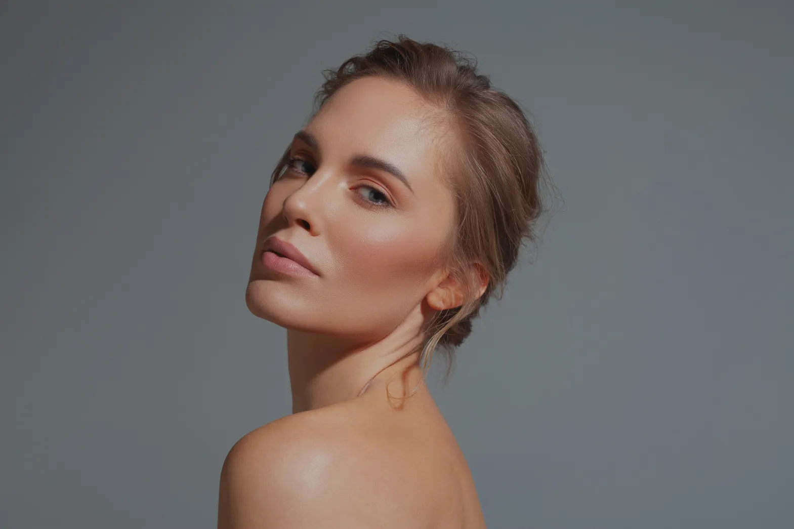 Woman smiling over shoulder