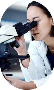 Scientist looking through microscope