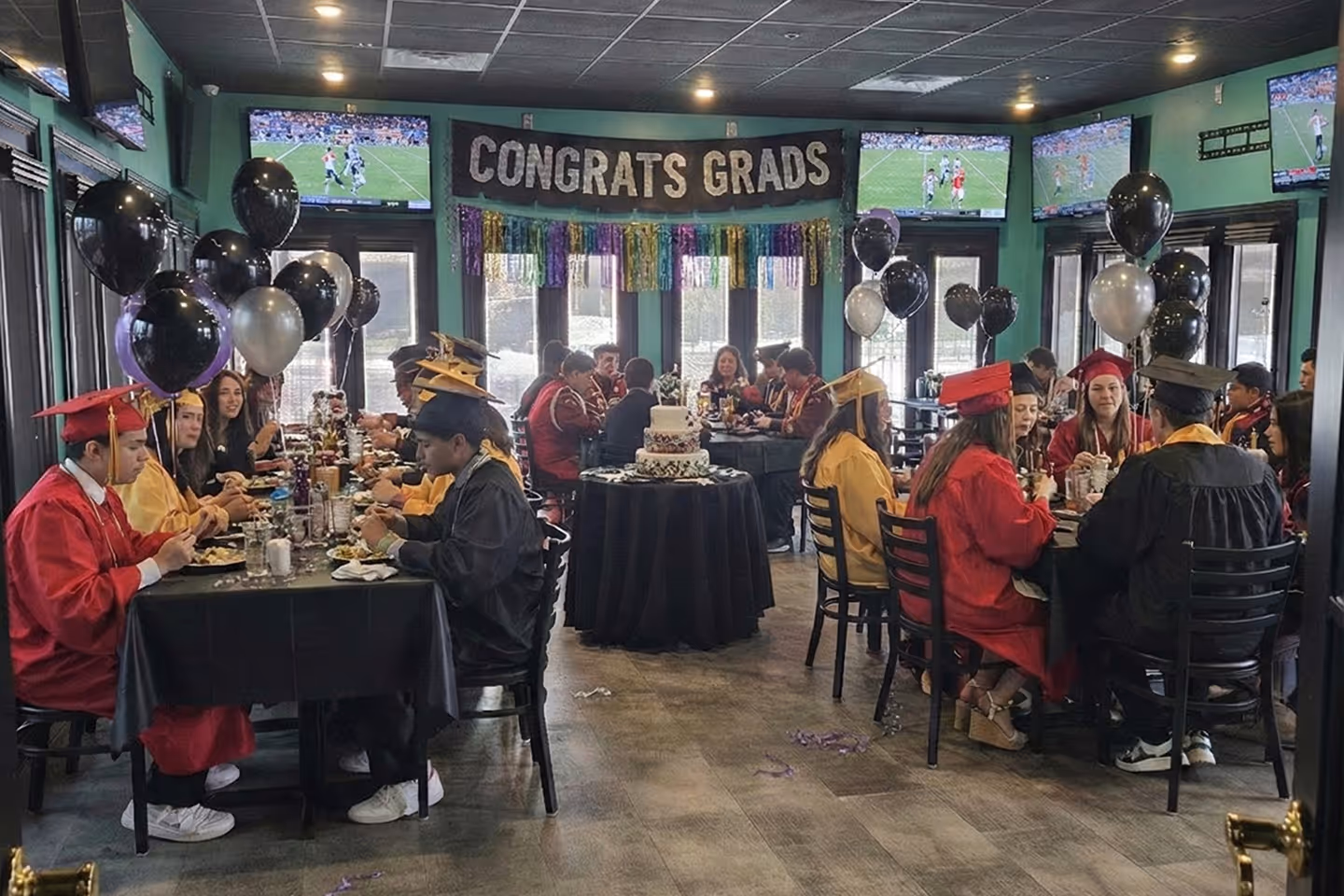 A spacious private dining area set with long wooden tables, ready for a large group celebration, with The Crab Shack decor in the background.