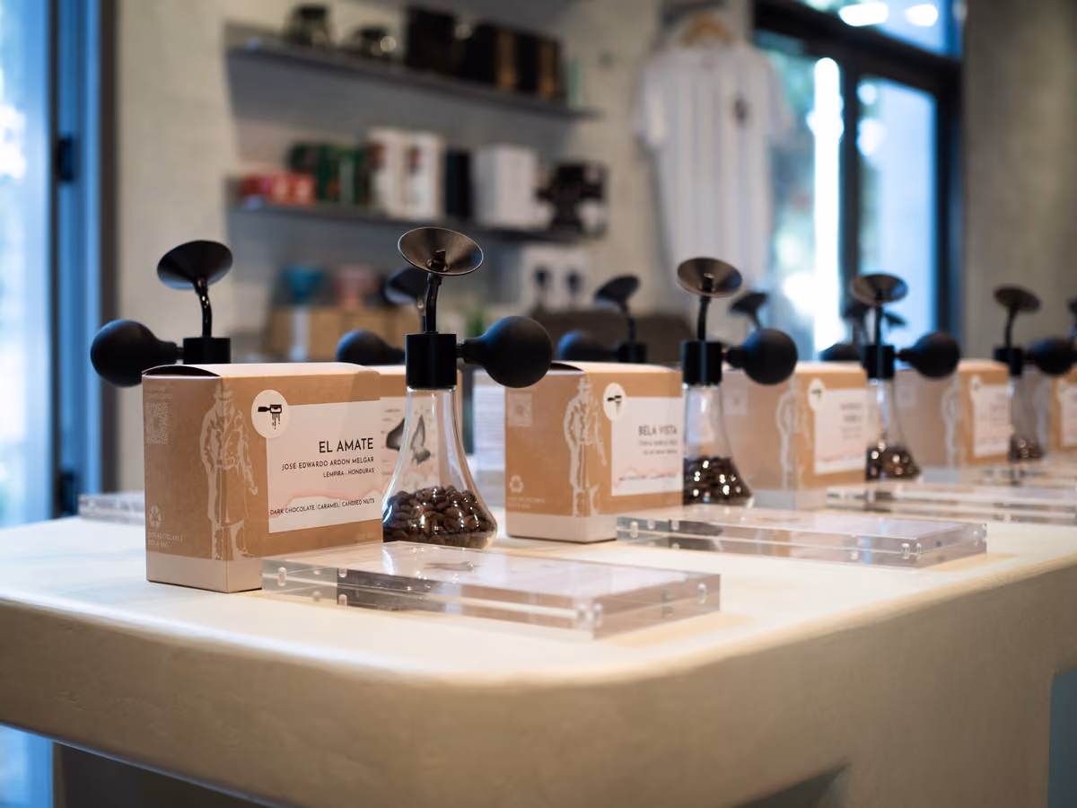 Contraband aroma table displaying coffee boxes and glass aroma vessels in the roastery