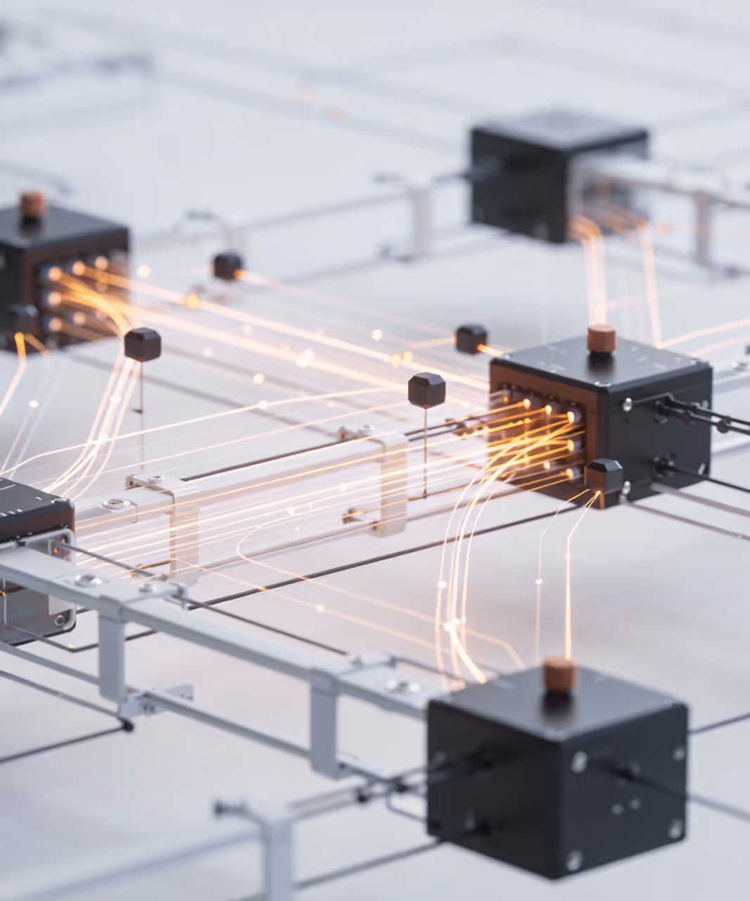 Close-up of interconnected black boxes with glowing orange light trails representing data flow in a network.