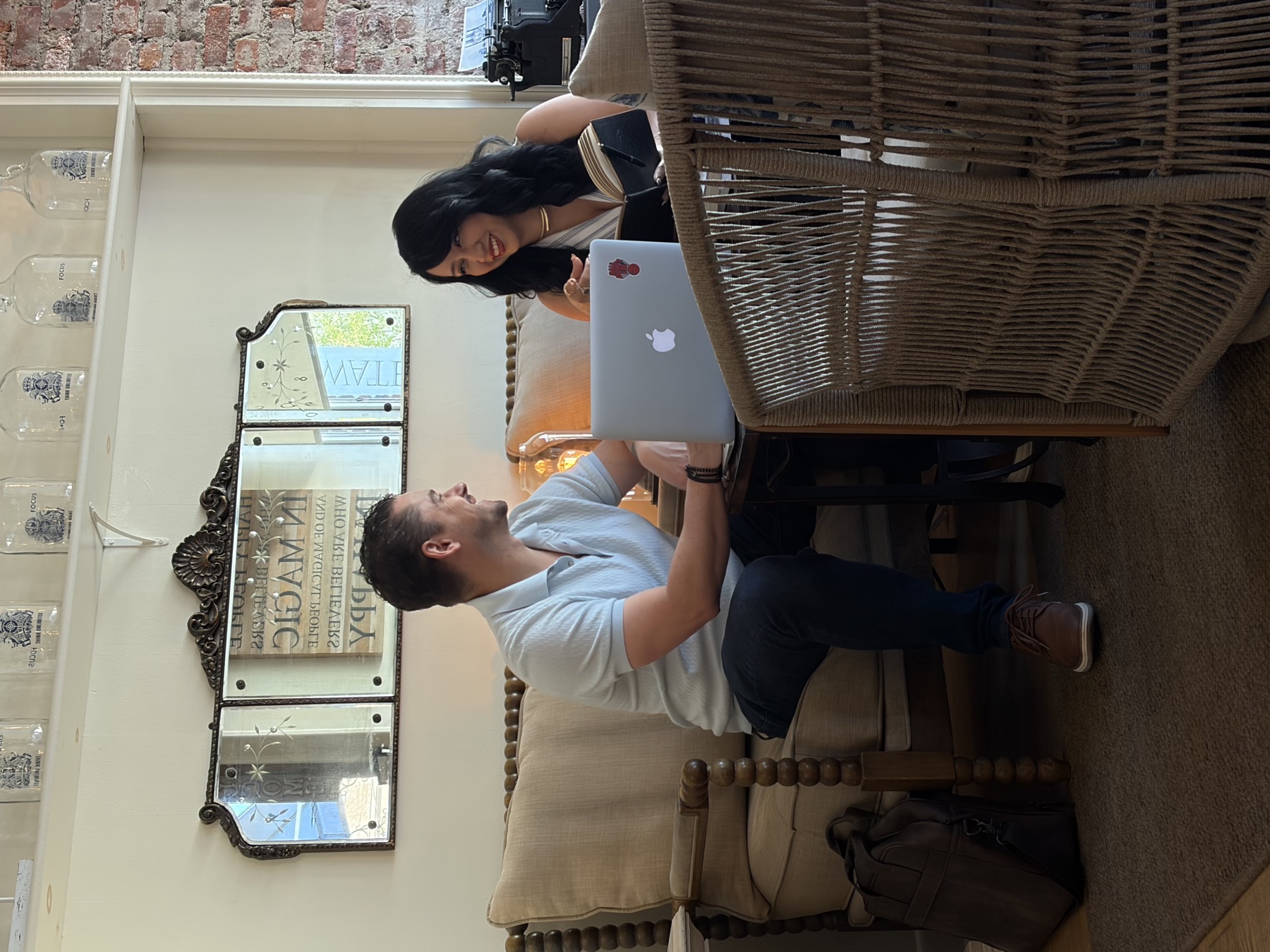 Scott and Andrea discussing a ClearGuide AI project at a café work session