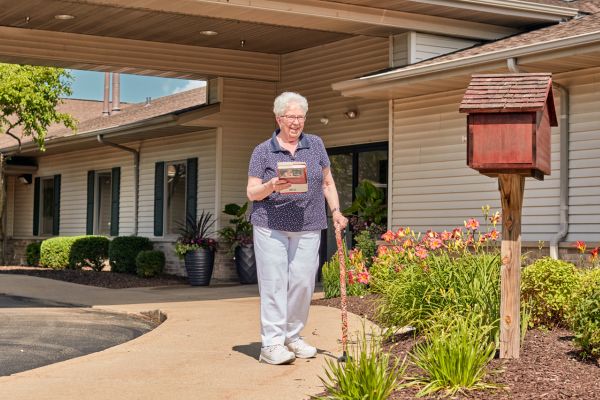 A resident enjoys a book outside of Highview in the Woodlands