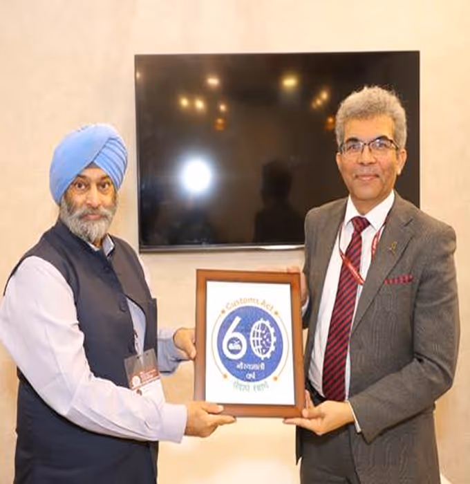 Two men standing and holding a framed certificate with a 60th anniversary logo.