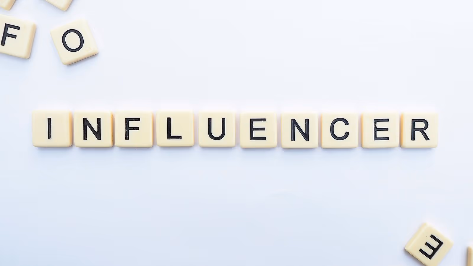Scrabble letters spelling the word influencer