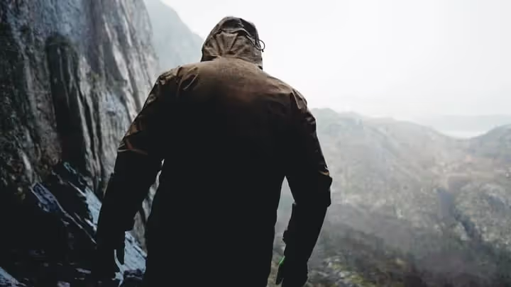 A kahuna team member walking through rocky terrain