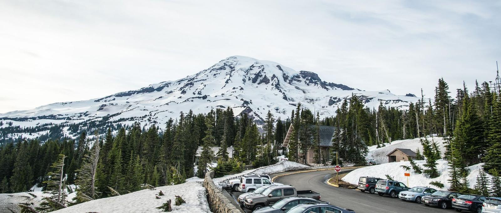 Washington — Scenic view of a snowy mountain landscape with parked cars.