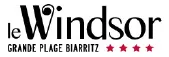 Logo with text 'le Windsor GRANDE PLAGE BIARRITZ' and five red stars.