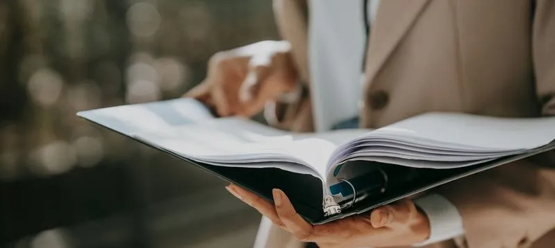 businesswoman with papers in folder