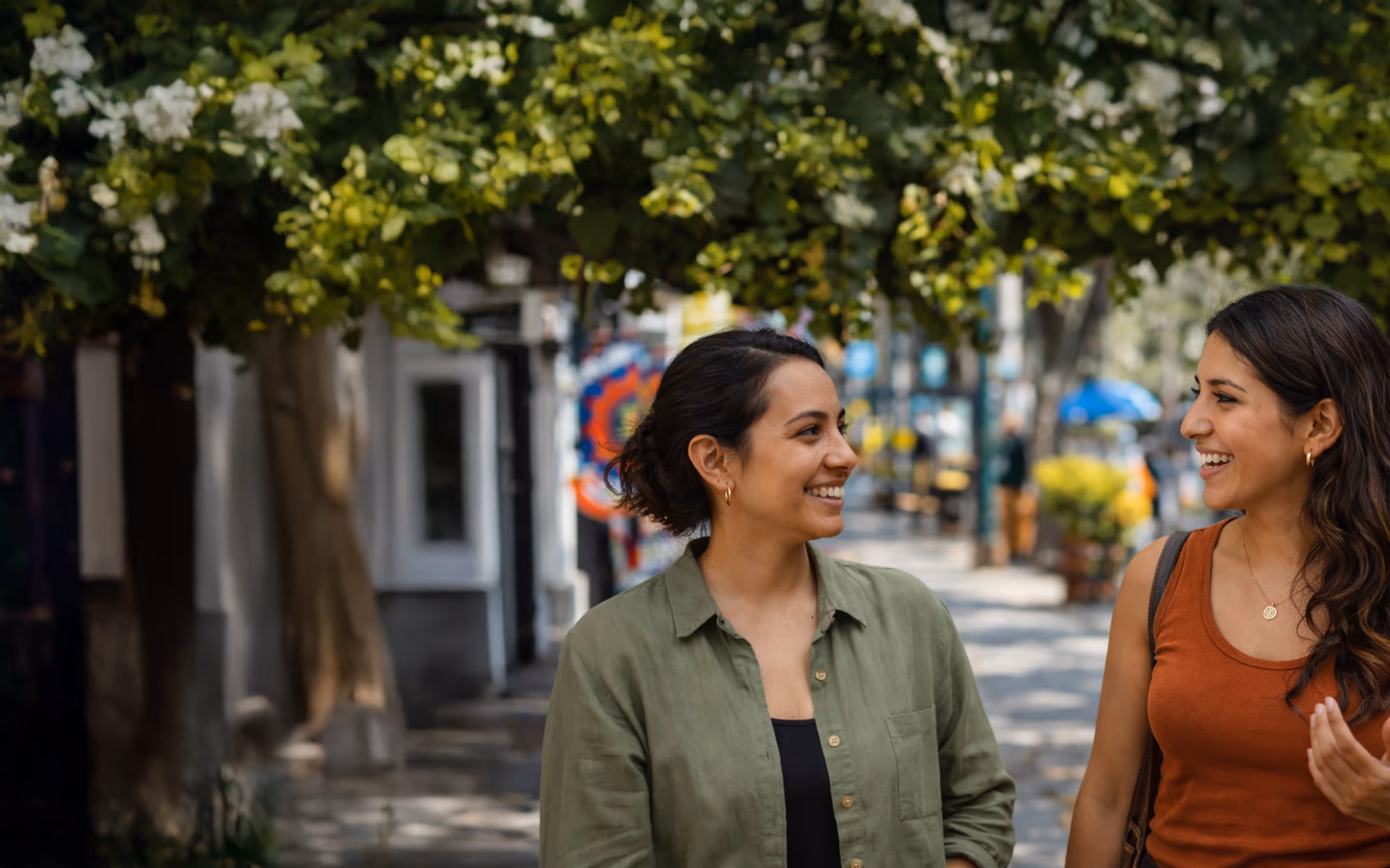two girls on the street wearing summer clothes, laughing