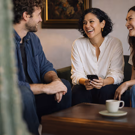 man and woman smiling in a bar
