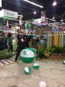 Man hitting beach volleyball at expo