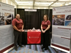 A man and a woman standing in front of the desk