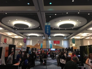Busy exhibition hall with booths and attendees