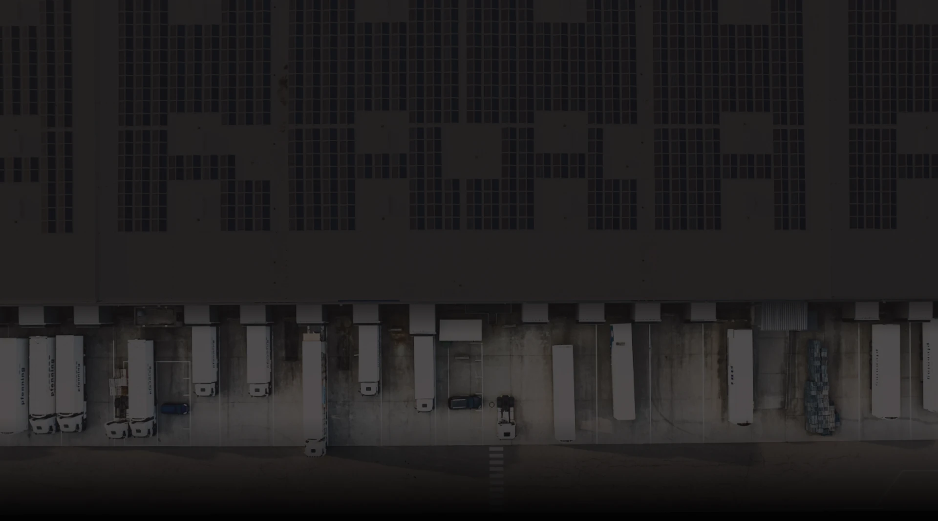 Aerial view of loading dock trucks lined up