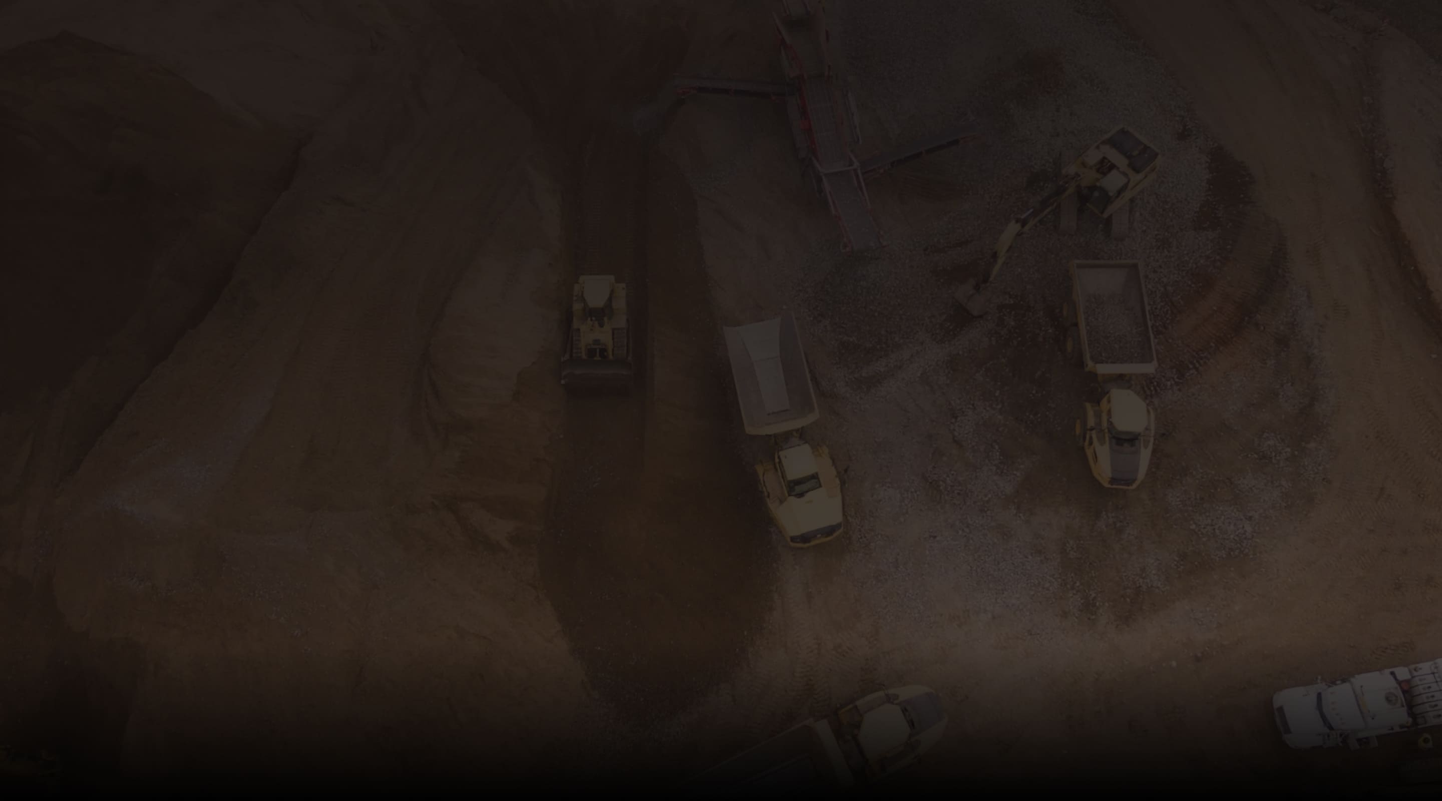 Dump trucks operate at an open-pit mine