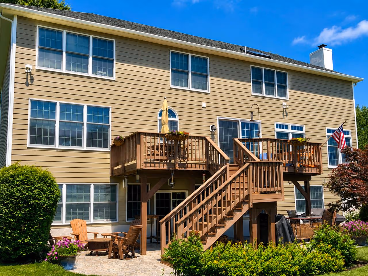 Full-home exterior siding replacement in Houston, showcasing flawlessly installed earth-tone lap siding that perfectly complements the large multi-level wooden deck.