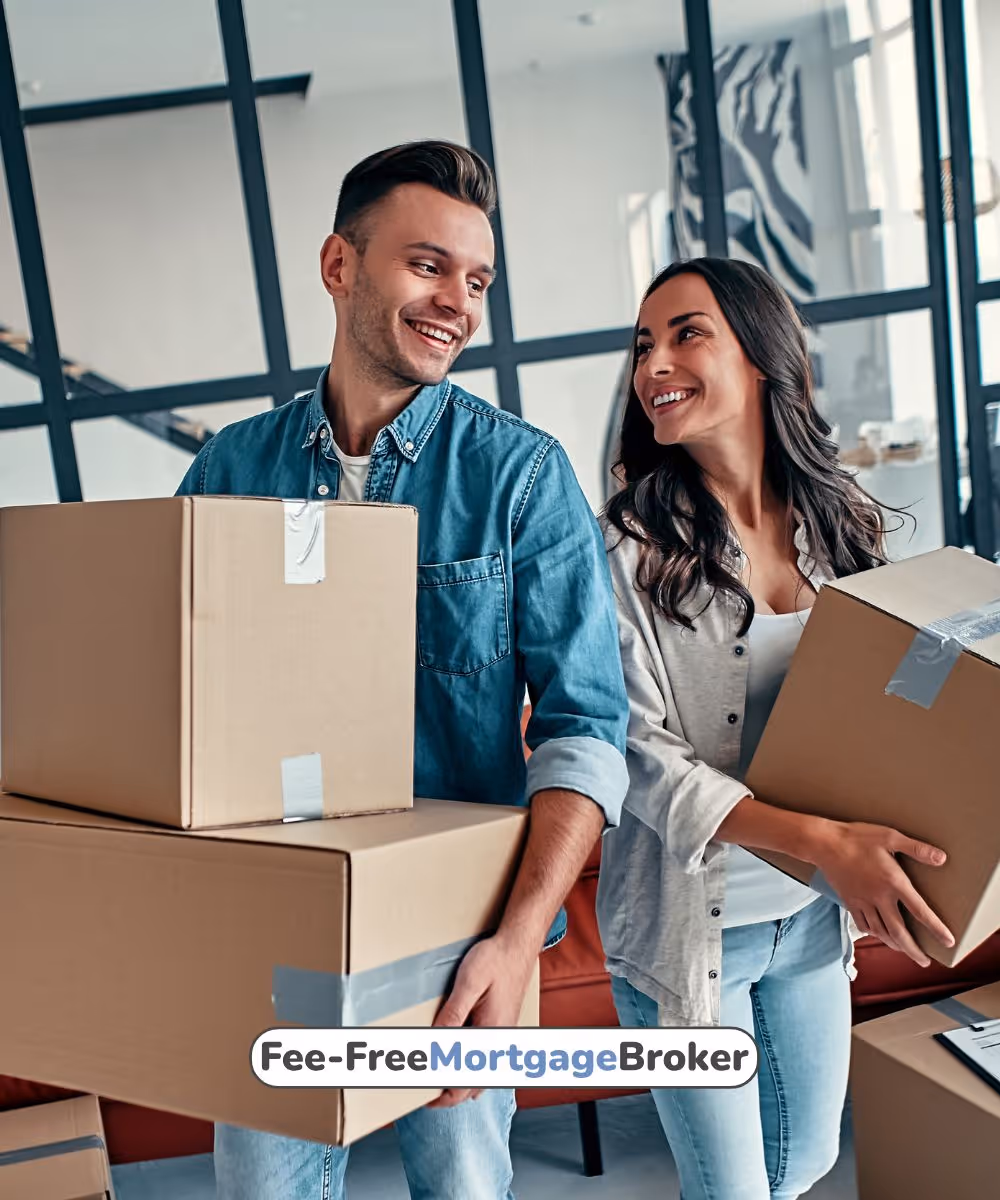 Smiling young couple carrying cardboard boxes while moving into a new home.