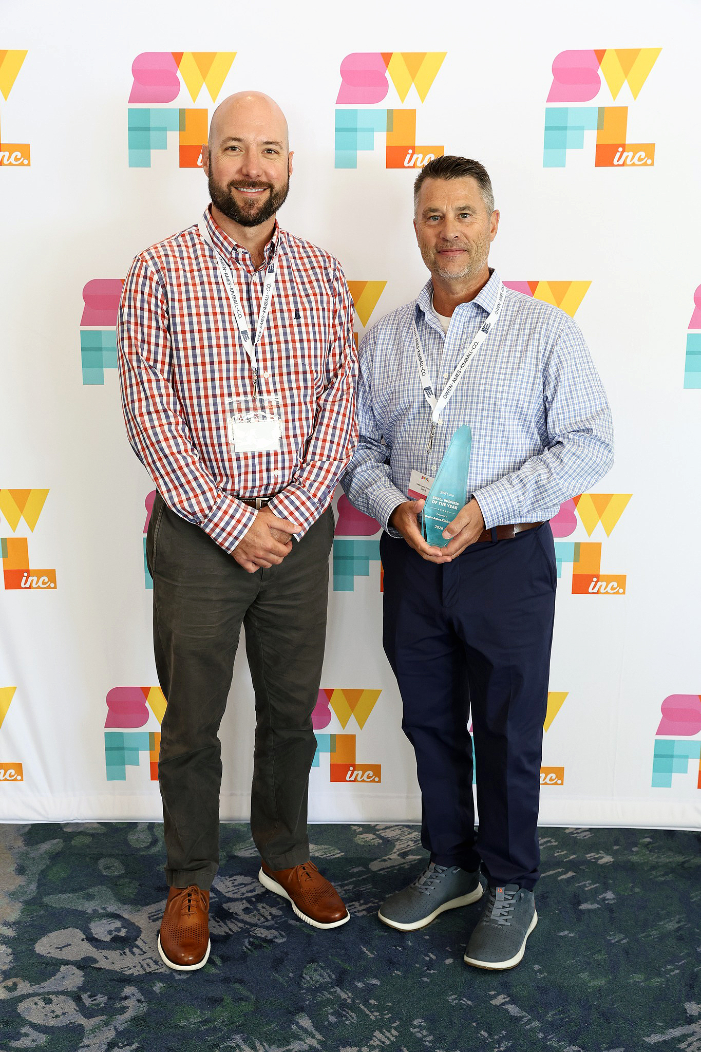 Rob Rotchadl (O-A-K Senior Director of Strategy and Finance) and Jim Hopper (O-A-K Florida President) pictured holding O-A-K's SWFL INCredible Award