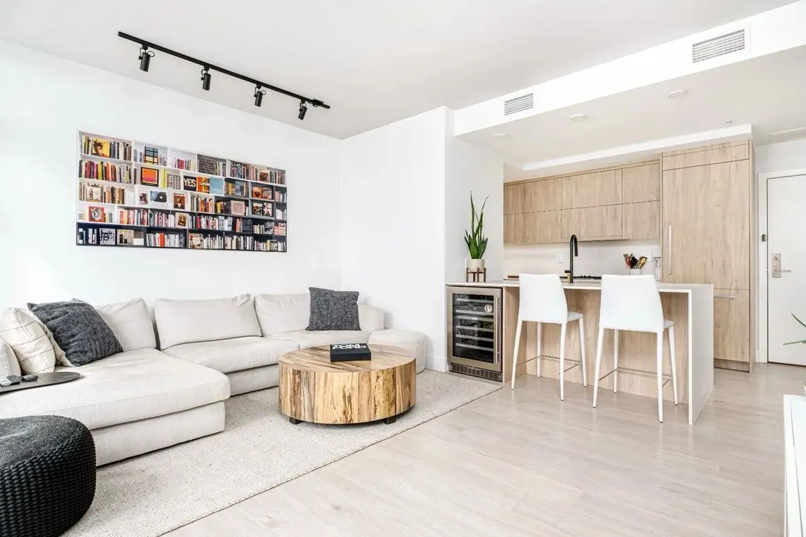 Open-plan living and kitchen cabinetry in the Olympic Village project