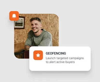 Smiling man sitting indoors next to a notification icon and text about geofencing for launching targeted campaigns to alert active buyers.