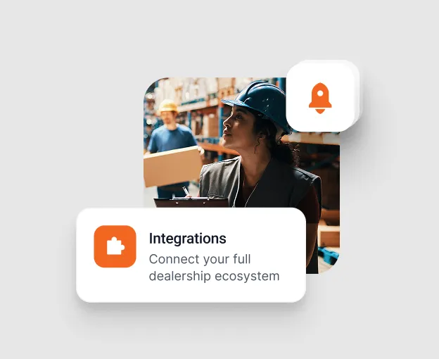 Woman wearing a blue safety helmet in a warehouse holding a clipboard, with a man carrying a box in the background and overlay text saying 'Integrations Connect your full dealership ecosystem.'