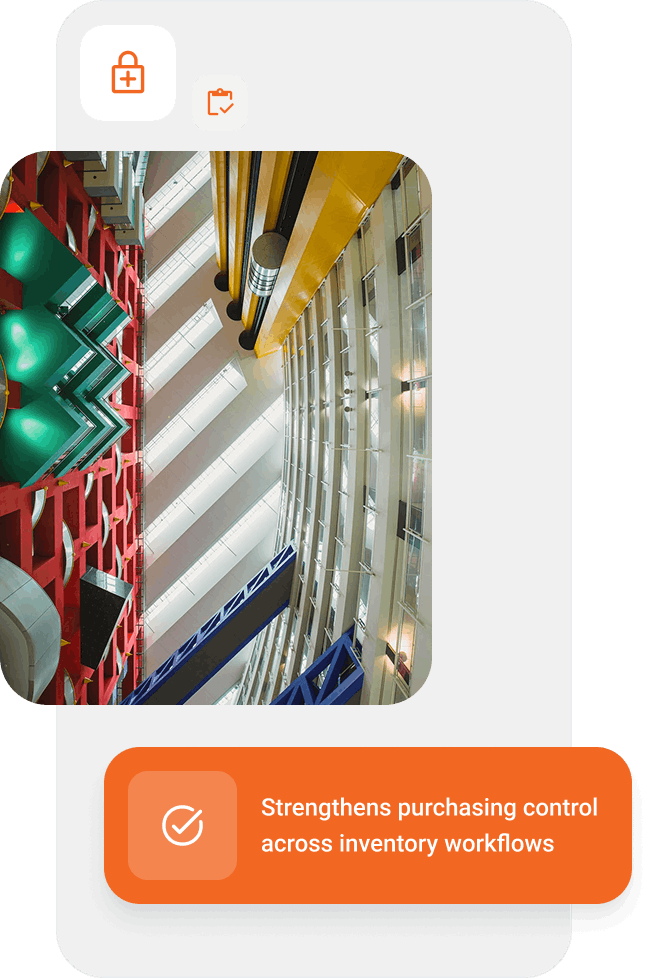 Interior view of a modern building with colorful structural beams in green, red, blue, and yellow under a skylight.