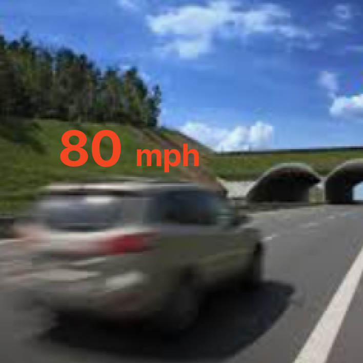 A fast-moving car driving on the freeway.